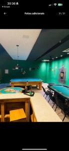 a ping pong room with ping pong tables at Loft reserva do Sahy- condado in Mangaratiba