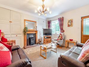 a living room with a couch and a fireplace at Halls Bank Farm in Plumbland