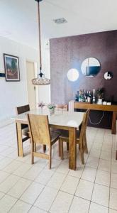 a dining room with a white table and chairs at Casa com 3 quartos carnaval Olinda in Olinda