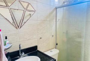 a bathroom with a shower and a sink and a toilet at Casa com 3 quartos carnaval Olinda in Olinda