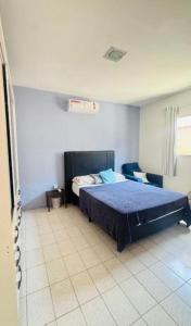 a bedroom with a blue bed in a room at Casa com 3 quartos carnaval Olinda in Olinda