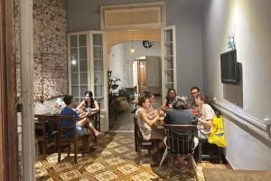 a group of people sitting at a table in a restaurant at Hostel Bohemian in Montevideo