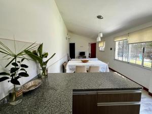 a room with a kitchen with a table in it at Casa con pileta Funes in Funes +9 photos