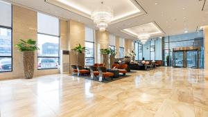 a lobby of a hotel with chairs and tables at Gloucester Hotel Jeonju in Jeonju