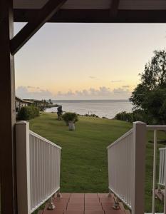 a view of the ocean from the porch of a house at Caribbean Lotus in Le François