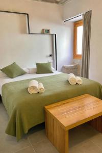 a bedroom with a large bed with towels on it at Hostal Boutique Restaurante El Algars in Caseras +85 photos
