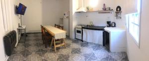 a small kitchen with a table and a stove top oven at Espacio Marea in Puerto Madryn