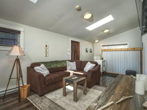 a living room with a couch and a table at Oceanfront view 2 entertainment areas -Pet Friendly in Port Renfrew