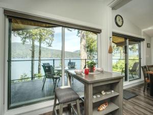 a dining room with a table and a large window at Oceanfront view 2 entertainment areas -Pet Friendly in Port Renfrew