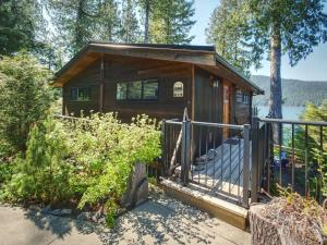 a cabin in the woods with a fence at Oceanfront view 2 entertainment areas -Pet Friendly in Port Renfrew +48 photos