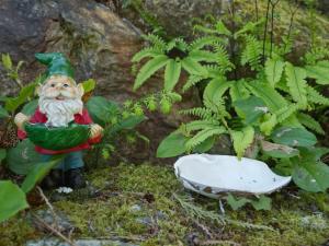 a statue of a gardener standing next to a plant at Oceanfront view 2 entertainment areas -Pet Friendly in Port Renfrew