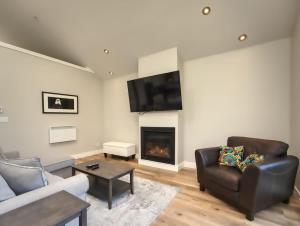 a living room with a couch and a fireplace at Oceanfront & Amazing Views - Pet Friendly - 2bdrm in Port Renfrew
