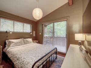 a bedroom with a bed and a large window at The Rocky Knoll - Garden View - Pet Friendly in Port Renfrew