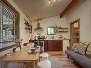 a living room with a table and a couch at The Rocky Knoll - Garden View - Pet Friendly in Port Renfrew +15 photos