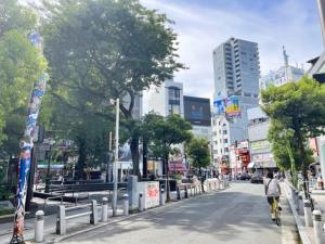 a person walking down a street in a city at Hotel LEAP in Osaka