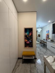 a living room with a painting on the wall at The Grand CentraL Studio & Люкс Студия в Центре Города Алматы in Almaty