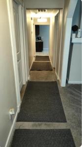 a hallway with several carpets on the floor of a room at Cozy Small Private Room 3 on McDaniel Street in Atlanta