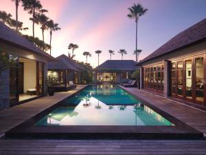 an exterior view of a villa with a swimming pool at Peppers Seminyak in Seminyak