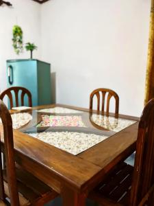 a dining room table with chairs and a glass top at Windy Oasis in Hikkaduwa +26 photos