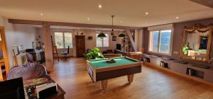 a living room with a pool table in it at La Ferme des Cherrieres - Piscine Intérieure Chauffée in Rupt-sur-Moselle