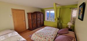 a bedroom with a bed and a dresser and a window at La Ferme des Cherrieres - Piscine Intérieure Chauffée in Rupt-sur-Moselle +78 photos