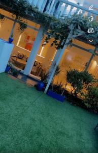 a large building with plants in a yard at Majorelle in Brussels