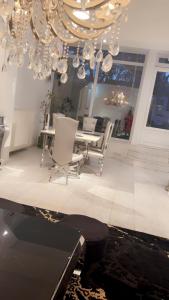 a dining room with a table and chairs and a chandelier at Majorelle in Brussels +1 photo