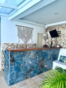 a bar in a room with a stone wall at Open Sea Hotel Cartagena - Frente al mar in Cartagena de Indias