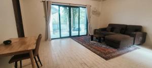 a living room with a couch and a chair and a table at Jeab Villa Kohphangan in Ko Phangan +2 photos