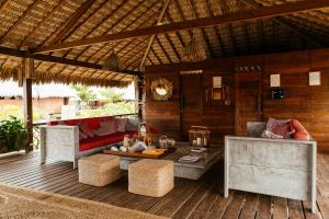 an outdoor patio with a couch and a table at Vila Guará in Atins
