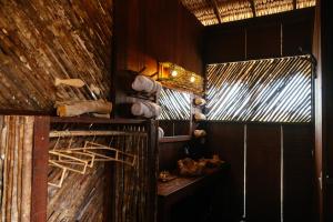 a bathroom with a wooden wall and a window at Vila Guará in Atins +222 photos
