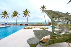 a hammock sitting next to a swimming pool at Resort beira mar in Porto De Galinhas +14 photos