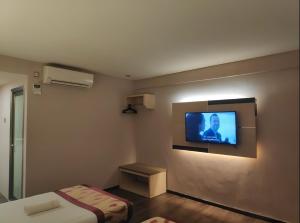 a room with a flat screen tv on the wall at Palace Inn in Miri