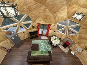 an overhead view of a living room in a wooden cabin at Domo loft puacura - tinaja disponible in Castro +12 photos