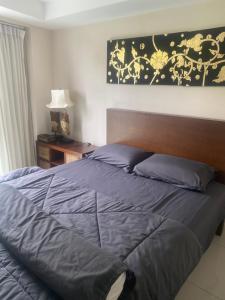 a bedroom with a large bed with blue sheets at Cristians lägenhet in Kata Beach +9 photos