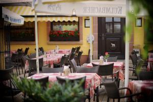a restaurant with tables and chairs with pink table cloth at Gasthof Weißes Lamm in Nuremberg