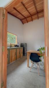 a kitchen with a wooden table and a chair at Villa Palm in Rekawa +11 photos