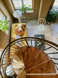 an overhead view of a spiral staircase in a living room at Designed House With Recycled Details In Österlen in Köpingebro +23 photos