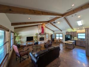 a living room with a couch and a fireplace at Wildcatter Ranch and Resort in Graham