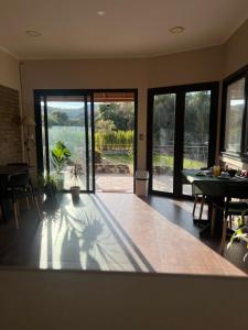 a living room with a table and a view of a patio at Anicca Posada in San Marcos Sierras