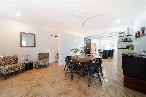 a living room with a table and chairs at Tranquility Retreat in Mission Beach