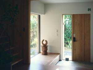 a pivot door in a room with a window at SANU 2nd Home MON Amami Oshima in Tatsugo