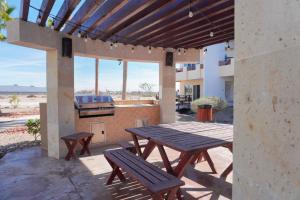 a picnic table and benches on a patio with a grill at Beach, Please MX in Puerto Peñasco