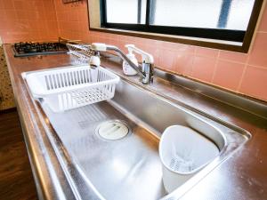 a kitchen sink with a dish drying rack in it at Villa228KASAMA in Kasama +36 photos