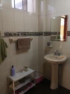 a white bathroom with a sink and a mirror at Large quiet apartment in condominium in Santa Eulalia +31 photos