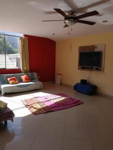 a living room with a couch and a flat screen tv at Large quiet apartment in condominium in Santa Eulalia
