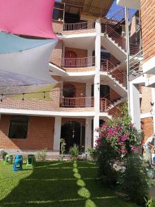 an apartment building with a yard with a building at Large quiet apartment in condominium in Santa Eulalia