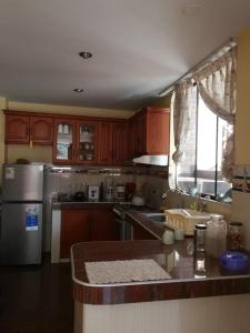 a kitchen with wooden cabinets and a counter top at Large quiet apartment in condominium in Santa Eulalia