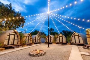 a group of domes with lights and a fire at Nadi Glamping Suites, Auto-City in Perai +104 photos
