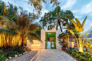 a entrance to a hotel with a green door at Nadi Glamping Suites, Auto-City in Perai